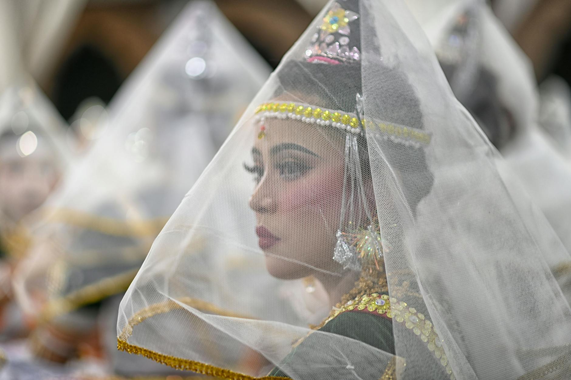 A Manipuri dancer adorned in traditional attire during a cultural performance in Imphal, India.