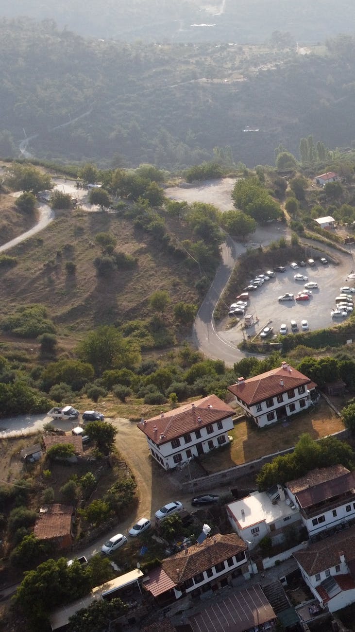 A scenic aerial view of Şirince village, showcasing traditional houses and lush landscape.