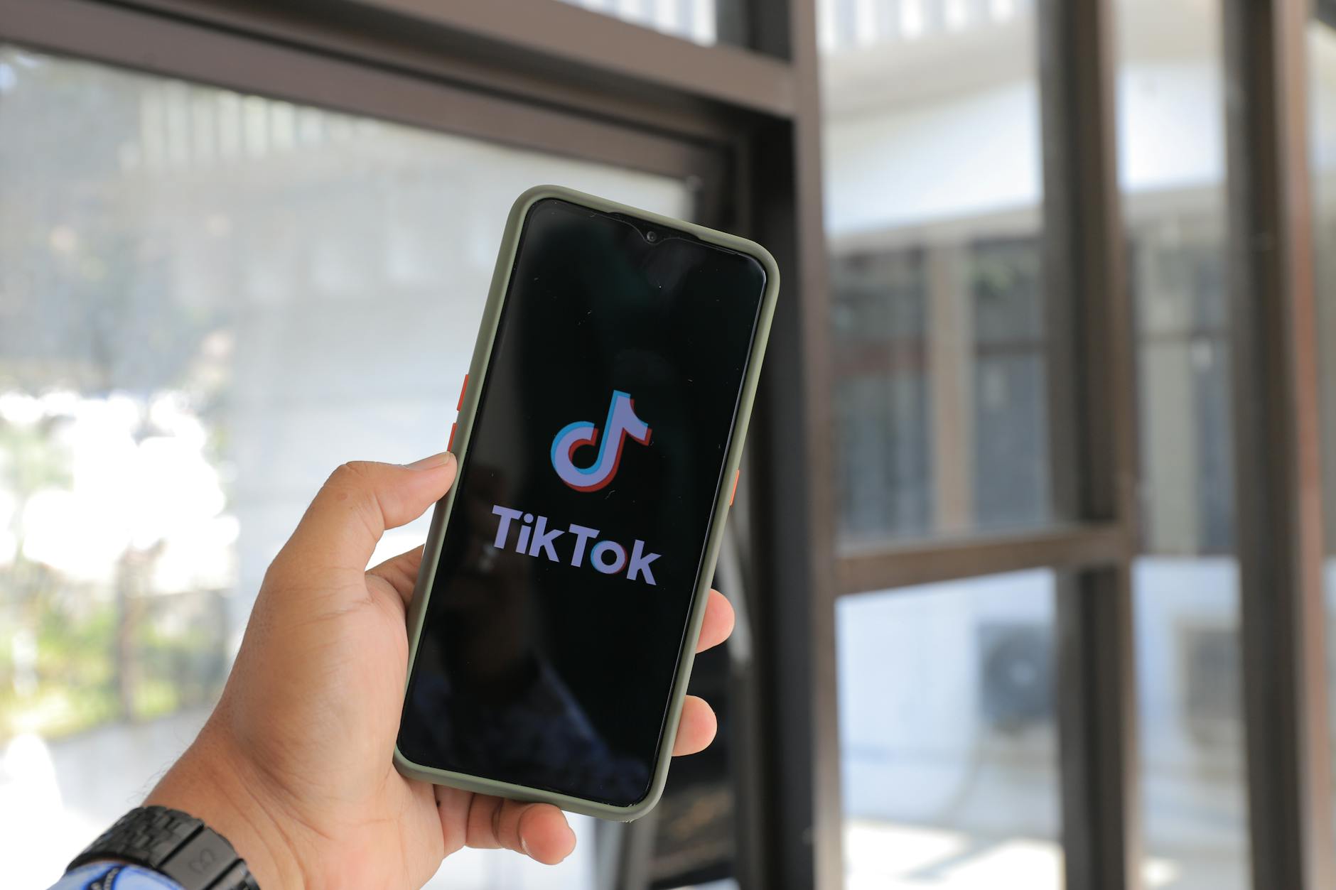 TikTok creator using trending sounds on phone screen